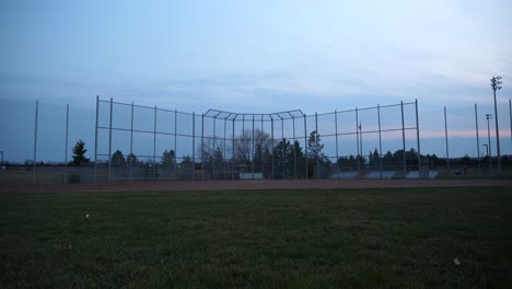static wide angle of baseball diamond at dusk, empty field at twilight