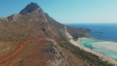balos beach in chania, crete, greece - scenic coastal landscape with rocky mountain slope. drone shot