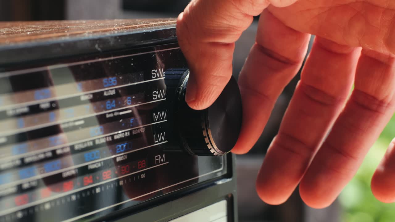 Person tuning a vintage radio