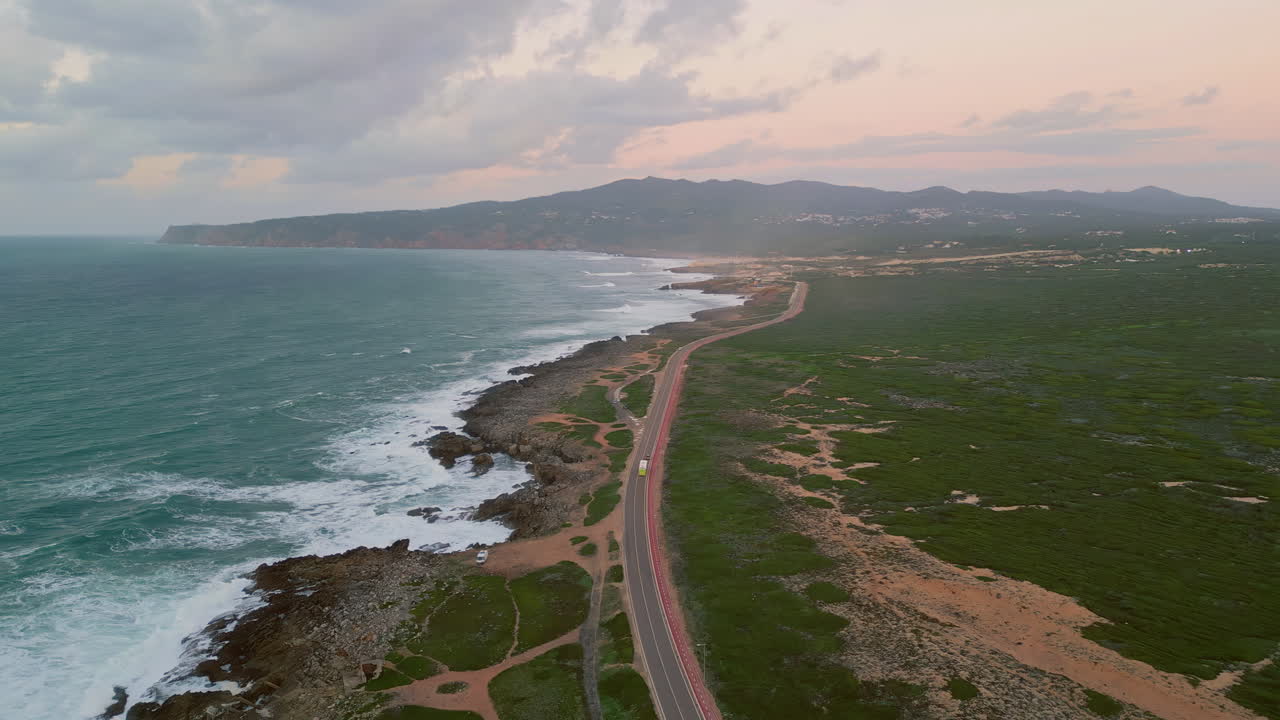 Coastal roadway stretching coastline aerial view. Asphalt road placed on coast