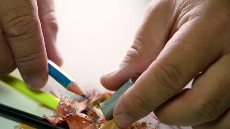 Footage-of-hands-slowly-sharpening-a-pencil-and-some-coloured-pencils-with-a-Wedge-Pencil-Sharpener