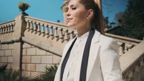 stylish young woman standing outdoors.