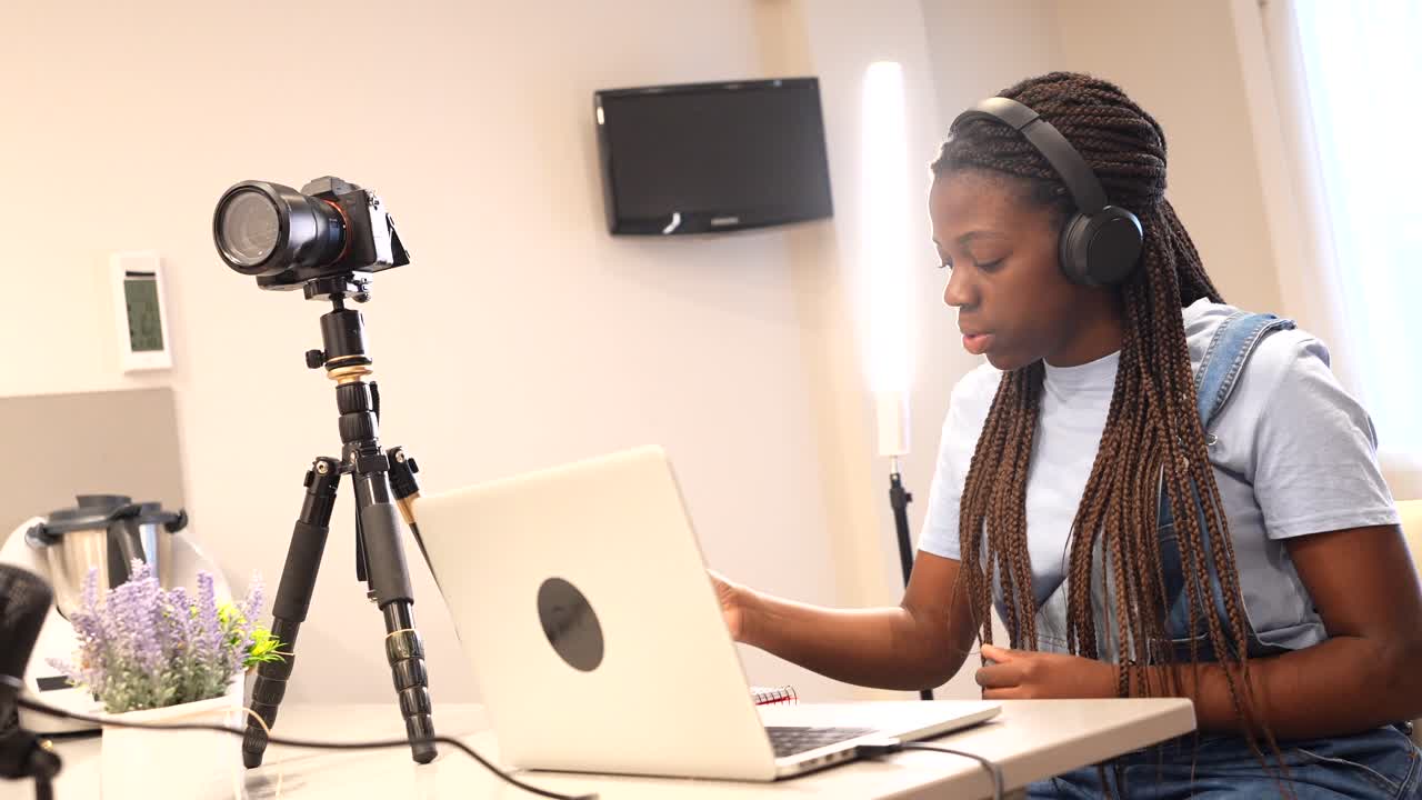 Woman Vlogging with Camera and Laptop