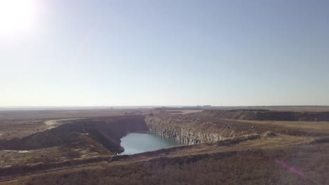 Drone-shot-of-birds-flying-towards-quarry