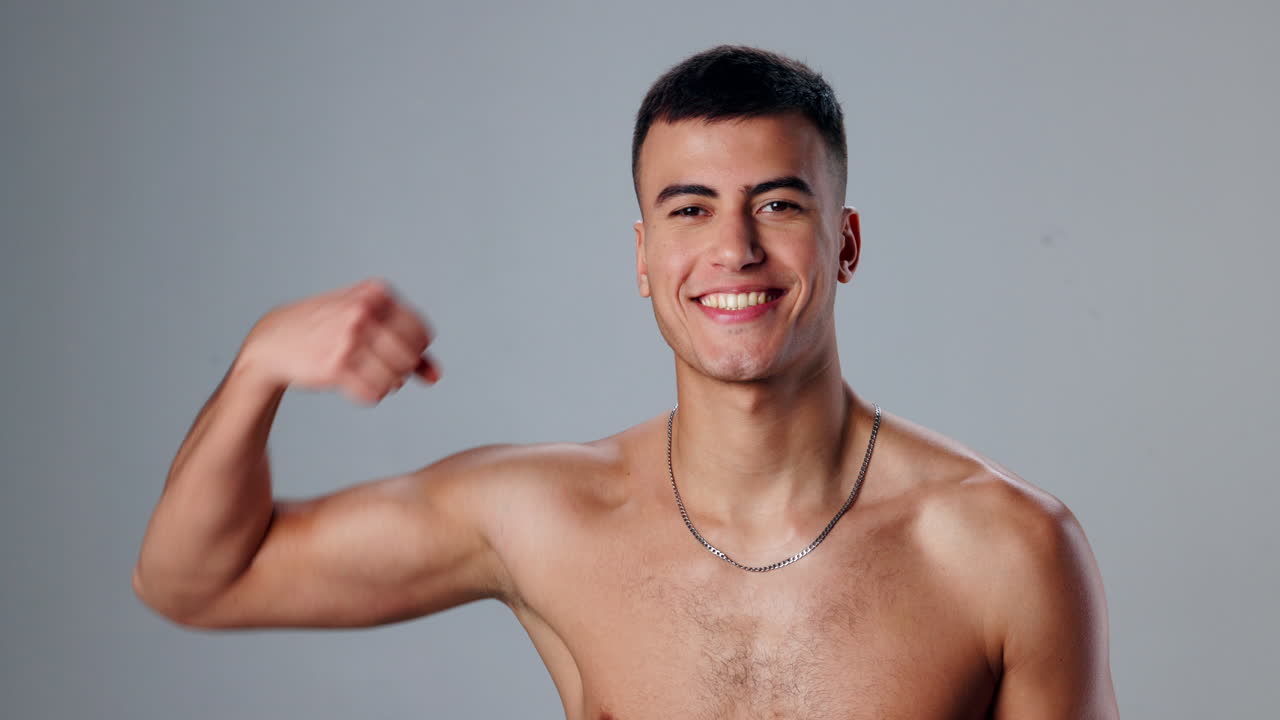 Shirtless man showing off biceps