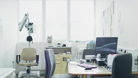 bright and modern medical doctor's office, complete with personal computer and ent, ophthalmology equipment.