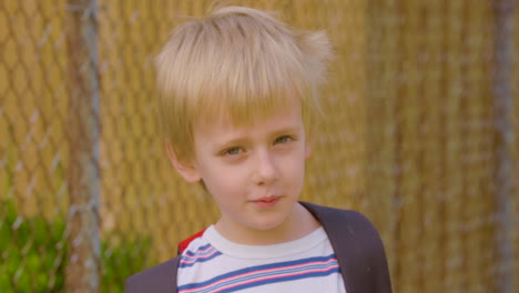 portrait of an adorable, blonde, little boy on his way to kindergarten