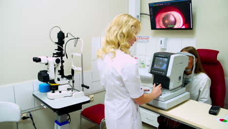 optometrist examining female patient. optometrist examines the sight of woman at eye clinic