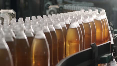 conveyor belt with bottles for juice or water at a modern beverage plant. modern production of sweet soda water