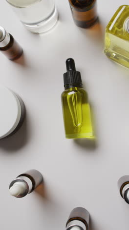 vertical video of different beauty products on white background