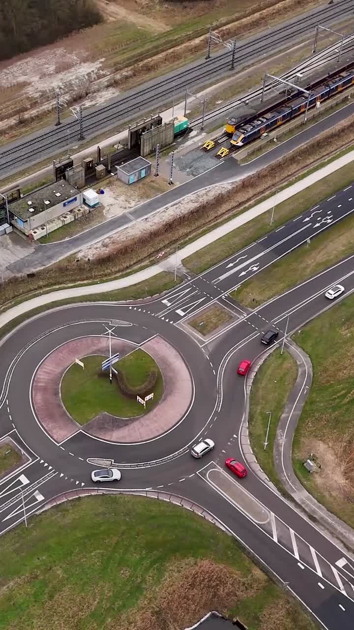 Aerial view of a roundabout with cars and a train