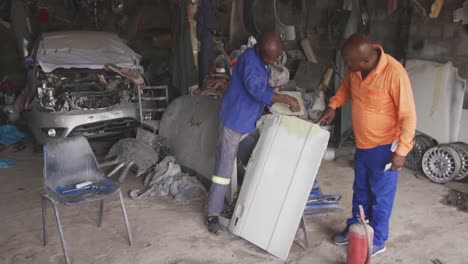 african man painting a car