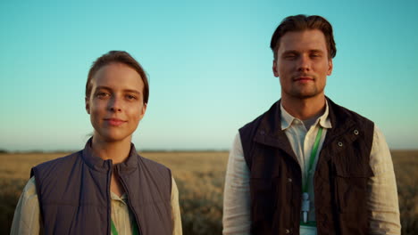 Portrait-farmers-couple-evening-countryside.-Farmland-managers-pose-together.