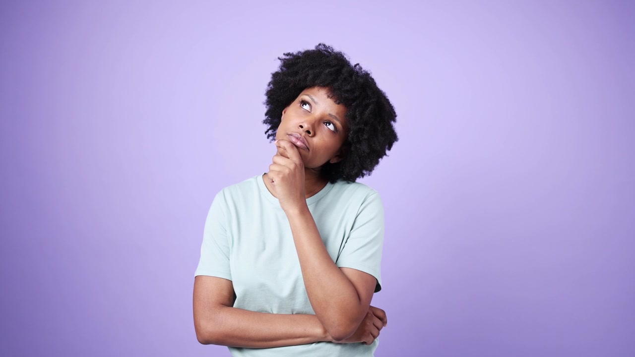 Young African American Woman Pondering and Looking Thoughtful