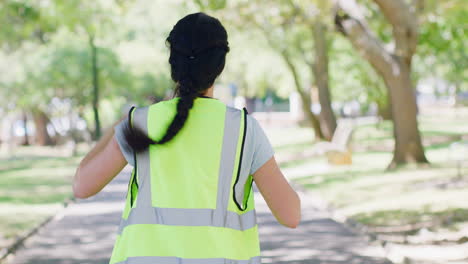 rearview of a woman putting on a reflective safety