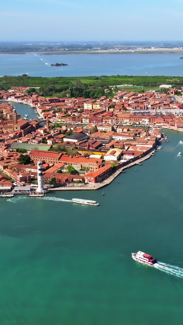 Distant aerial drone view of Murano Island, Venice, Italy on a sunny day. Vertical