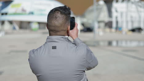 happy young middle eastern blogger recording video with phone