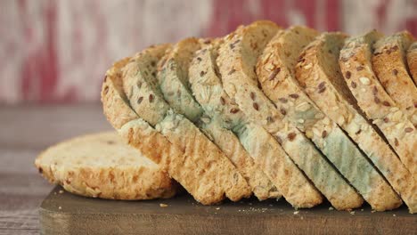 moldy sliced bread on cutting board