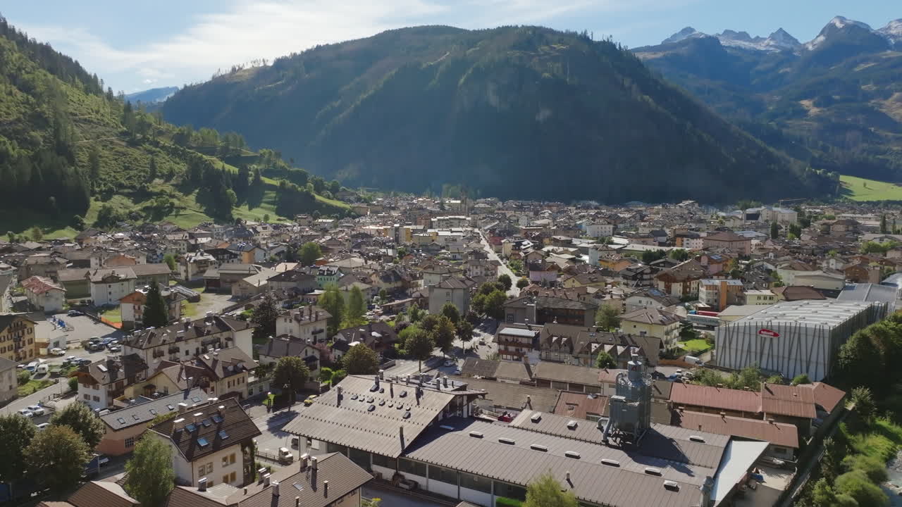 Aerial footage slowly rotating around the small downtown of a town in northern Italy during the day.
