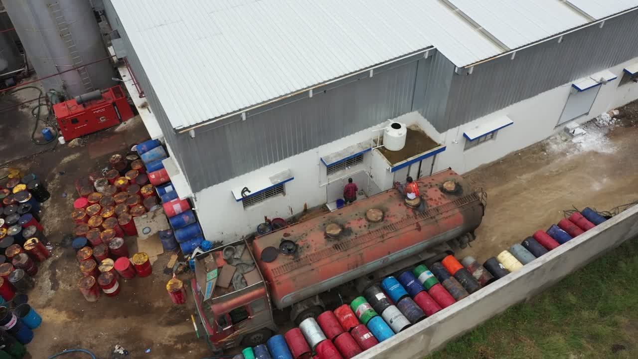 aerial drone view man is filling a petrol of tanker, industry 5.0