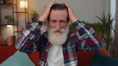 Close-up-of-happy-beautiful-bearded-senior-elderly-grandfather-man-smiling-looking-at-camera-at-home