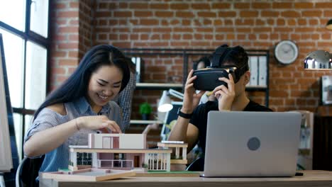 man exploring 3-d house model in goggles