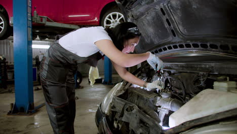 woman repairing car