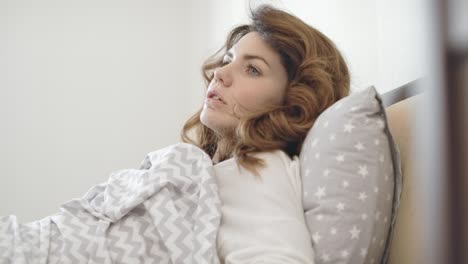 pretty woman sleeping in bedroom. female person waking up from horror dream.