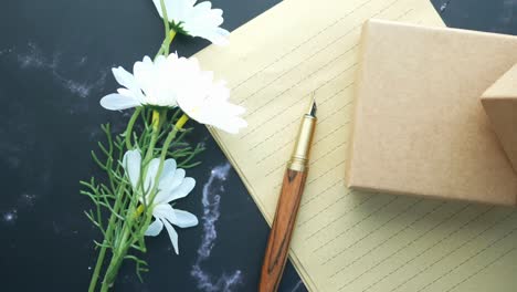 elegant gift and writing setup with flowers