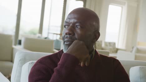 Video-of-thoughtful-senior-african-american-men-sitting-in-living-room-alone