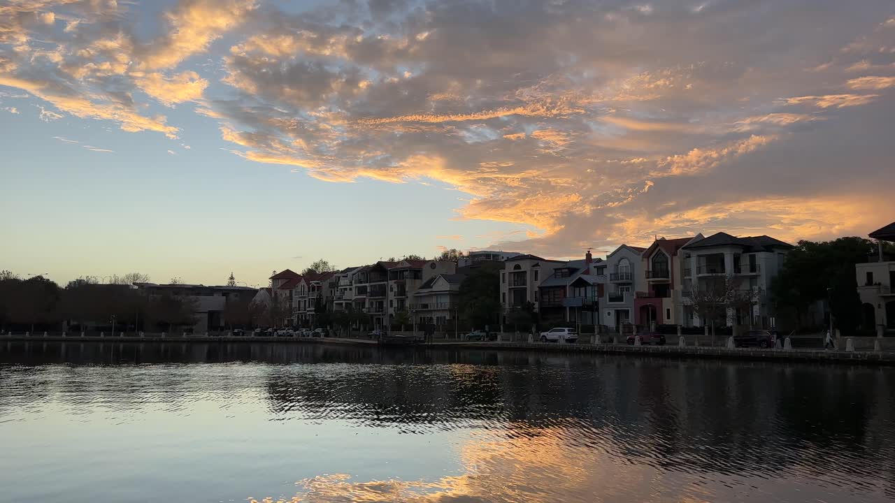 Waterfront Buildings and Sunset Reflections