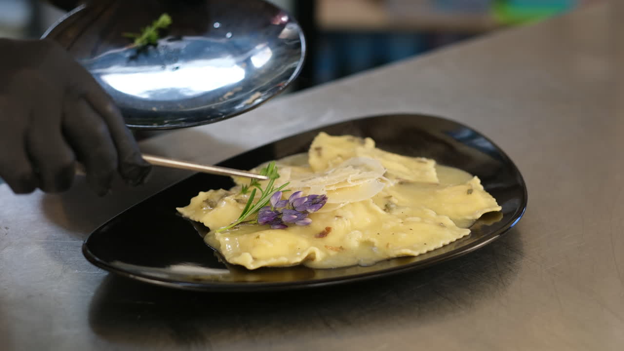 Chef Plating Delicious Raviolis with Creamy Sauce