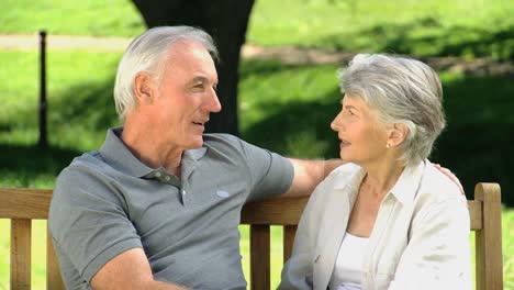 Old-man-talking-with-his-wife-on-a-bench