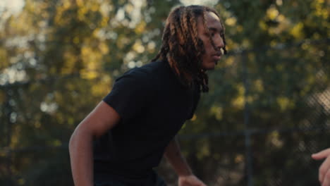young man playing basketball outdoors