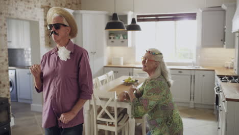 a senior couple playing dress-up