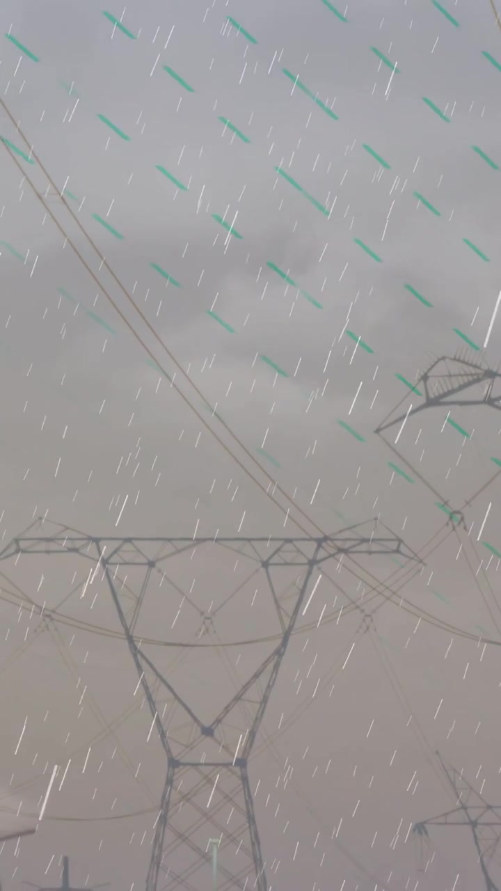 Vertical video: Camera panning down showing lattice tower rain streaking emphasizing power corridor