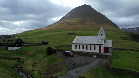 viðareiði church, faroe islands: aerial view of the church and the nearby mountain