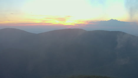 an aerial shot of cole mountain seen from the mount pleasant summit during a summer evening at sunset