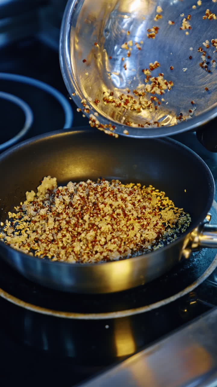 Cooking the food in the frying pan. A cook puts the seeds or porridge into the pan. Close up. Vertical video.