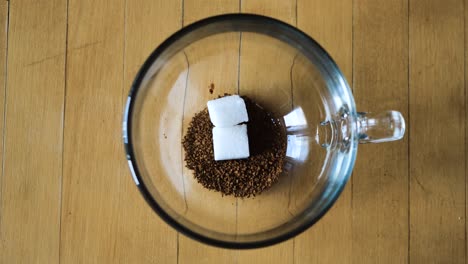 pouring coffee into a glass mug