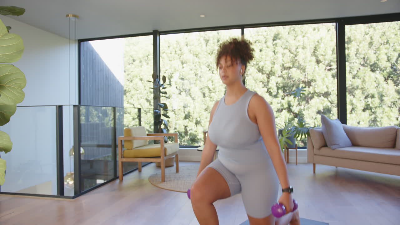Allenandosi a casa, donna curvy che solleva manubri sul tappetino da yoga, con spazio per il testo.