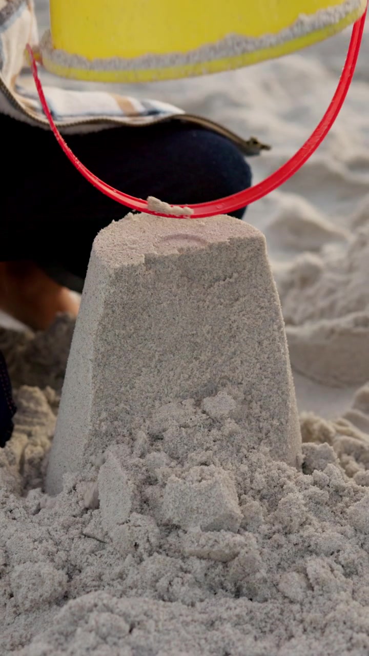 Child Making a Sandcastle on the Beach