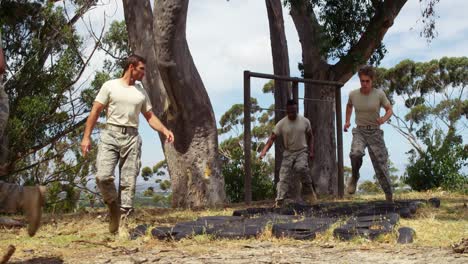 Military-troops-running-over-tyres-during-obstacle-course-4k