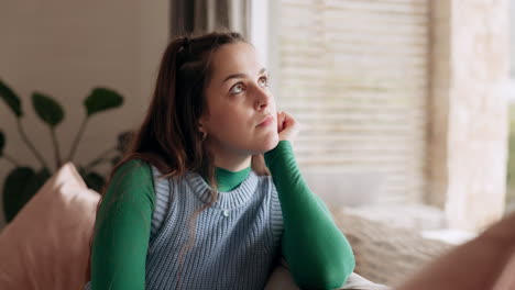 thinking, sad and young woman in the living room