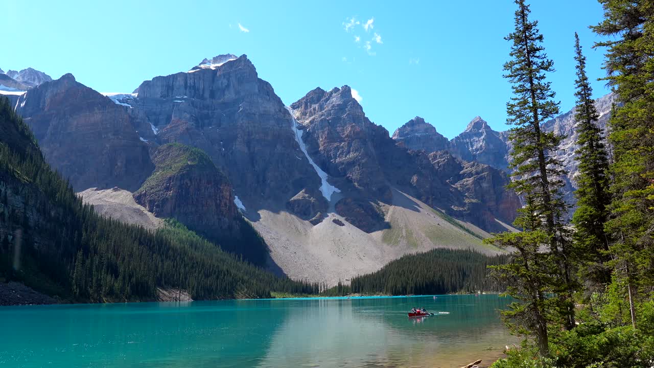 Scenic view of Moraine Lake with mountains and canoe