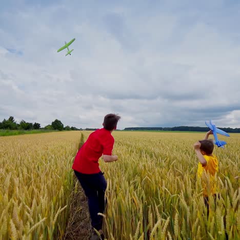 boys running with plane toy