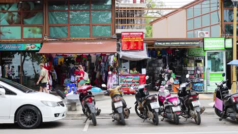 people and vehicles on a bustling thai street