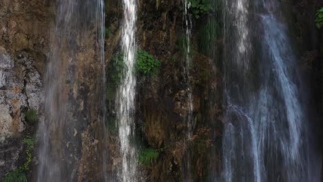 tight aerial shot pulling away from a tiered waterfall in sopotnica, serbia