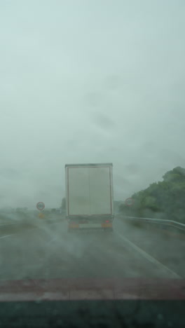 truck driving on wet highway road