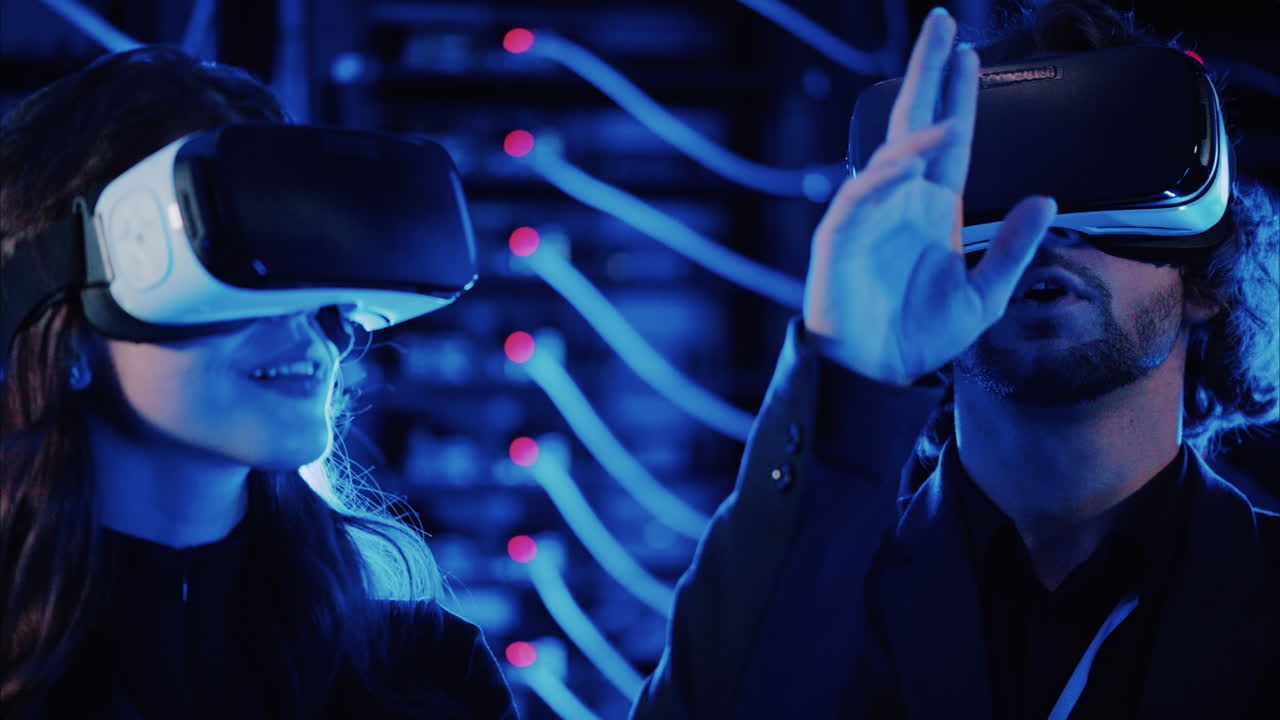 A man and a woman using Virtual Reality headsets in a server room